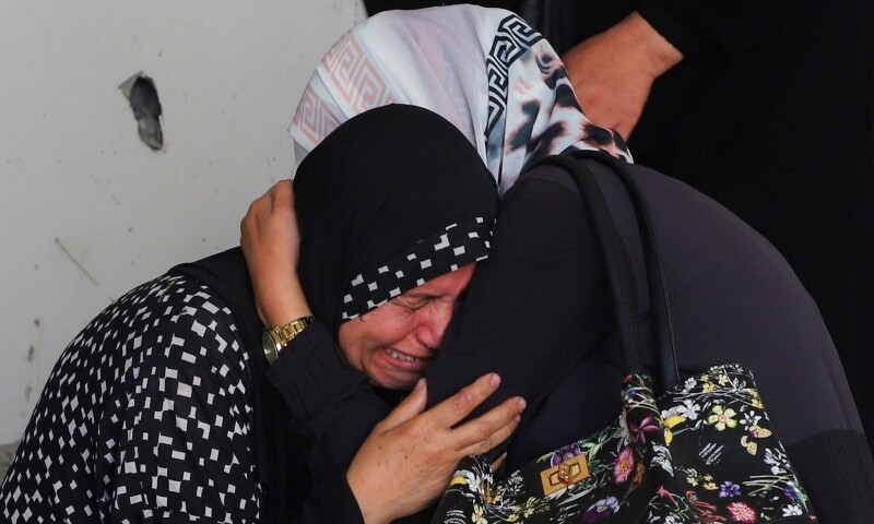 The reaction of grandmother of a three-year-old child, who survived an Israeli air strike on a house that killed his parents and two sisters, in Gaza City, Sept. — Reuters