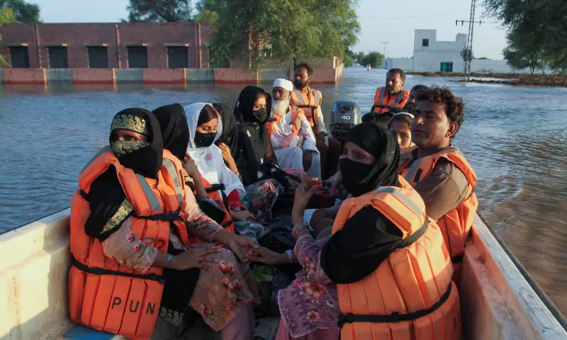 Residents sit in a rescue boat as they evacuate following monsoon rains and rising water levels in the Chenab river, in Punjab&rsquo;s Basti Khan Bela, on the outskirts of Jalalpur Pirwala, on September 10, 2025. &mdash; Reuters