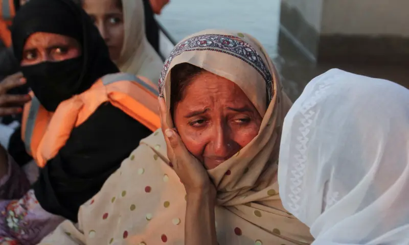 Shagufta Bibi, whose son drowned after a recue boat was capsised, is comforted by a relative as she evacuates following monsoon rains and rising water levels in the Chenab river, in Punjab&rsquo;s Basti Khan Bela, on the outskirts of Jalalpur Pirwala, on September 10, 2025. &mdash; Reuters