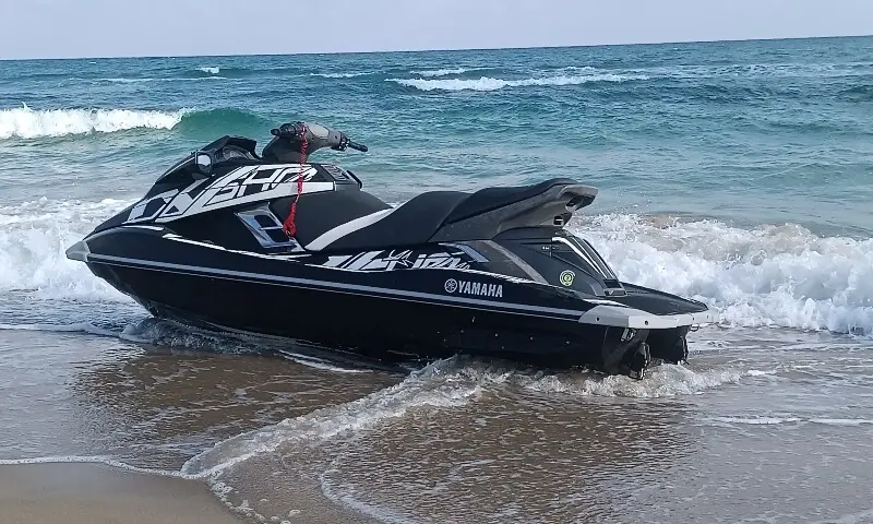 A jet ski is beached before Muhammad Abu Dakha and two other Palestinian migrants on a beach near Khums, Libya, August 17. — Reuters