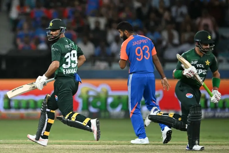 Pakistan’s Fakhar Zaman (L) and Sahibzada Farhan run between the wickets as India’s Jasprit Bumrah (C) watches during the Asia Cup 2025 Super Four Twenty20 international cricket match between India and Pakistan at the Dubai International Stadium in Dubai on September 21, 2025. — AFP