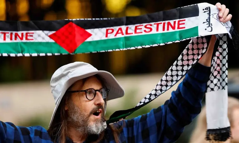 A man holds a banner with &ldquo;Palestine&rdquo; written on it, during a pro-Palestinian protest in Portland, Oregon, US on October 7. &mdash; Reuters