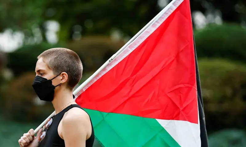 A demonstrator holds a Palestininan flag during a pro-Palestinian protest in Portland, Oregon, US on October 7. &mdash; Reuters
