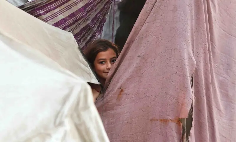 A Palestinian girl reacts while sheltering at a tent, after US President Donald Trump announced that Israel and Hamas agreed on the first phase of a Gaza ceasefire, in Khan Younis in the southern Gaza Strip on October 9. &mdash; Reuters
