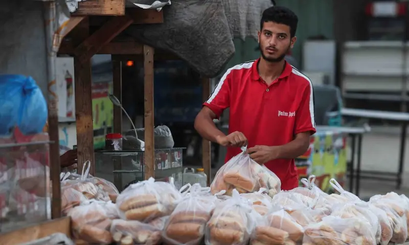 A Palestinian bread seller packages items at his shop after US President Donald Trump announced that Israel and Hamas agreed on the first phase of a Gaza ceasefire, in Khan Younis in the southern Gaza Strip October 9. &mdash; Reuters