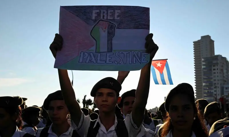 A young man holds a sign during a rally in support of Palestinians in Gaza, after U.S. President Donald Trump announced that Israel and Hamas agreed on the first phase of a Gaza ceasefire, in Havana, Cuba on October 9. &mdash; Reuters