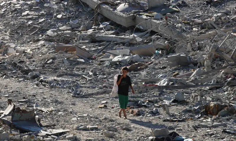A Palestinian boy walks among rubble following Israeli forces&rsquo; withdrawal from the area, amid a ceasefire between Israel and Hamas in Gaza, in Khan Younis, in the southern Gaza Strip on October 11. &mdash; Reuters