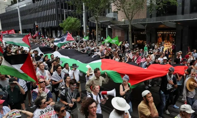 Demonstrators hold a large Palestinian flag during the &lsquo;Nationwide March for Palestine&rsquo;, after a ceasefire between Israel and Hamas in Gaza went into effect, in Sydney, Australia, October 12. &mdash;Reuters