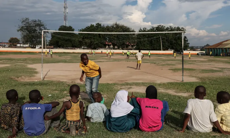 Children watch a soccer match at a local pitch in Ilorin, Kwara State, Nigeria, September 26, 2025. — Reuters