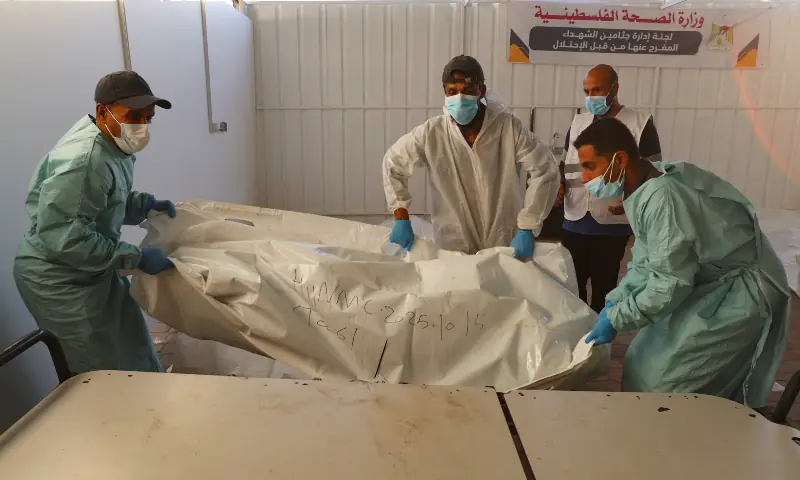  Members of a medical team move a body, which was handed over to the Red Cross after they were released by Israel, amid a ceasefire in Khan Younis, southern Gaza Strip on October 15, 2025. &mdash; Reuters/Ramadan Abed 