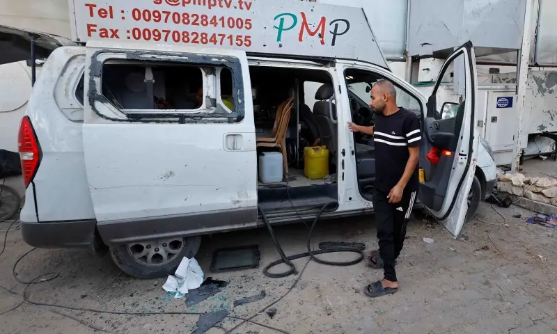 A Palestinian inspects the site of an Israeli airstrike that targeted a residential compound housing employees of the Palestine Media Production Company in Zawaida in the central Gaza Strip on October 19. &mdash; Reuters