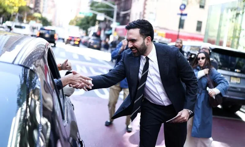 Democratic socialist candidate Zohran Mamdani greets people on the street in the Manhattan borough of New York City during early voting for the upcoming mayoral election, on October 27. —AFP