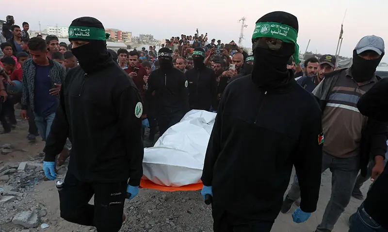 Hamas fighters carry a dead body during a search for deceased captives seized during the October 7, 2023 attack on Israel, in Khan Younis, the southern Gaza Strip on October 28. — Reuters