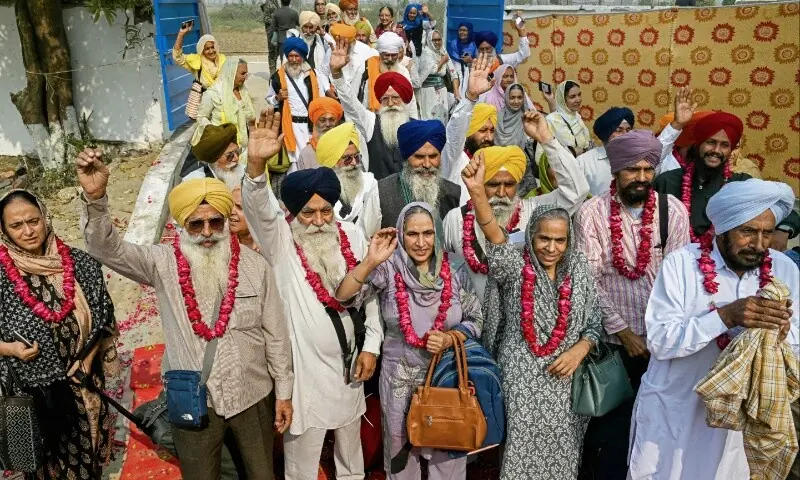 Indian Sikh pilgrims gesture upon their arrival in Pakistan after crossing the India-Pakistan Wagah border in Wagah on November 4, 2025, on the eve of celebrations marking the birth anniversary of Guru Nanak, founder of Sikhism. — AFP/ Narinder Nanu