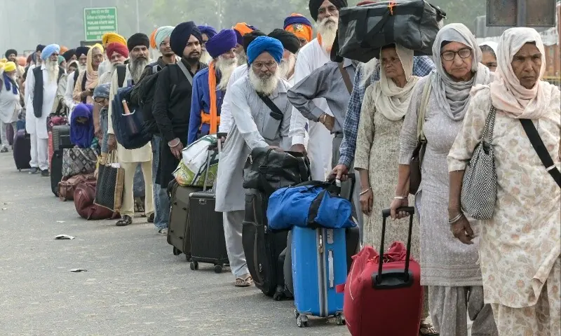 Indian Sikh pilgrims queue at the India-Pakistan Wagah border in Wagah on November 4, 2025, for their visit to Pakistan to pay their respects on the eve of celebrations marking the birth anniversary of Guru Nanak, founder of Sikhism. — AFP/ Narinder Nanu