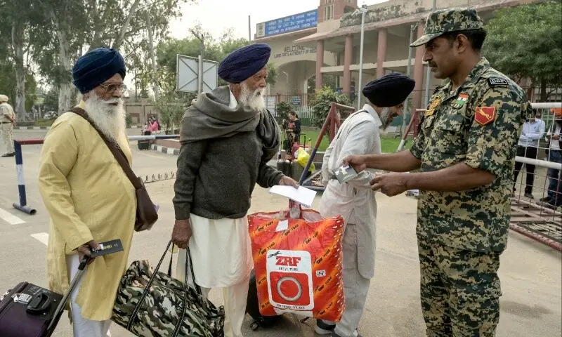 An Indian Border Security Force (BSF) personnel inspects passports and documents of Indian Sikh pilgrims as they head to Pakistan through the India-Pakistan Wagah border in Wagah on November 4, 2025, on the eve of celebrations marking the birth anniversary of Guru Nanak, founder of Sikhism. — AFP/ Narinder Nanu