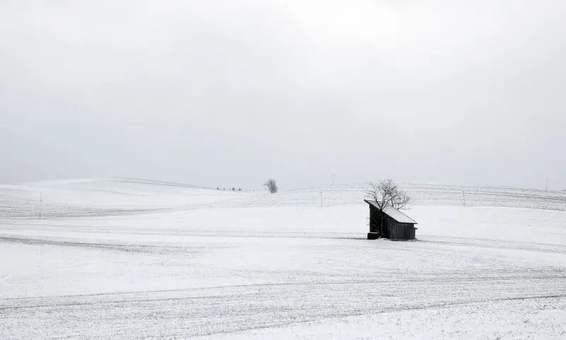 A wooden cabin stands in the snow-covered landscape in Gorisried, Germany on November 20. — AFP