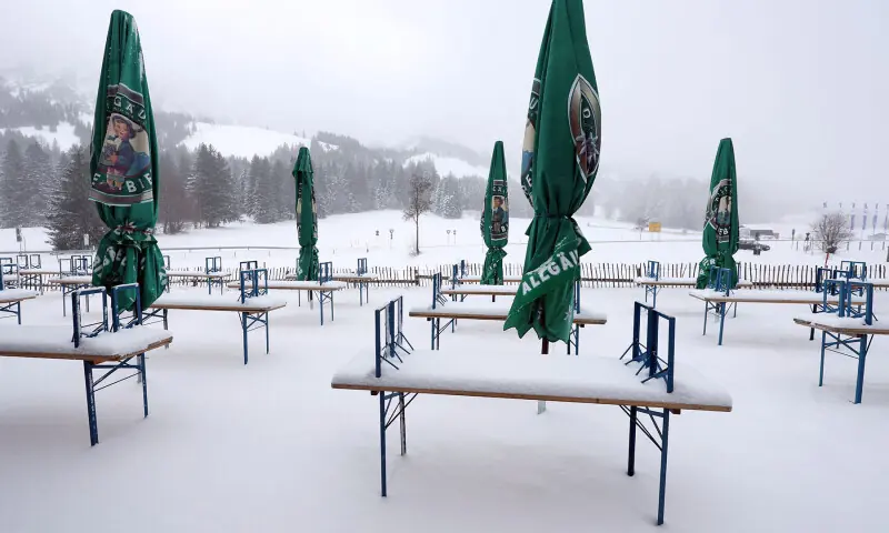 Benches and tables of a closed beer garden stand in the snow in Bad Hindelang, Germany on November 20. — AFP