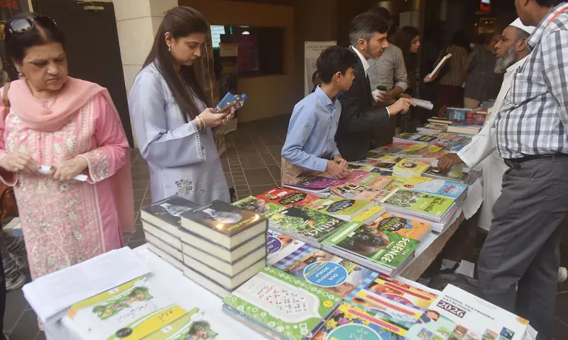 Visitors look at books on sale at the Adab Festival in Karachi on November 22. —Fahim Siddiqui