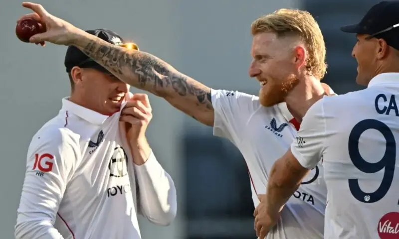 Ben Stokes celebrates his five wickets with teammates on day 1 of the first Ashes cricket Test match. — AFP