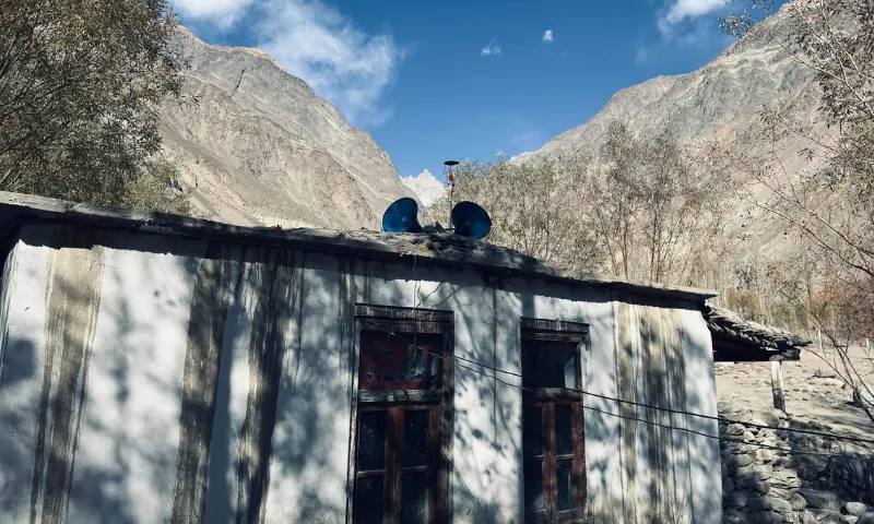 The tiny mosque with loudspeakers on the roof and behind, you can see the top of the mountain covered with snow. This is where the flood initially started.