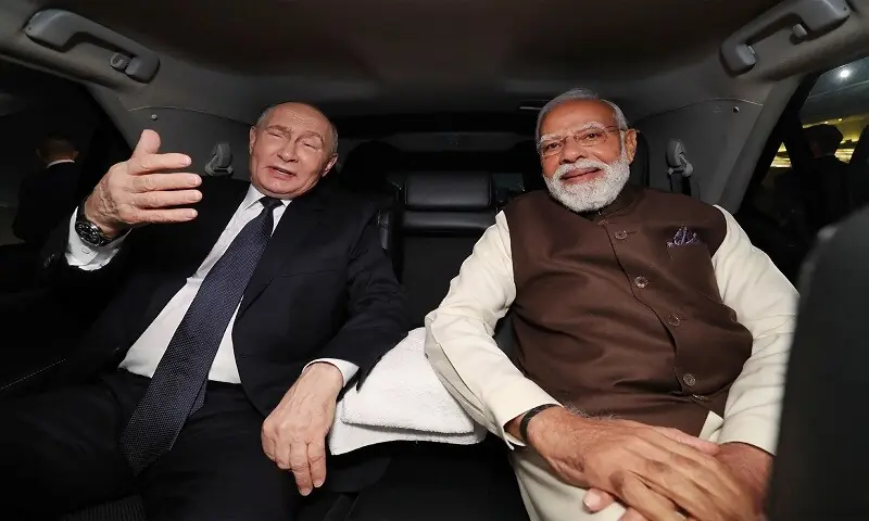 India’s Prime Minister Narendra Modi (R) and Russia’s President Vladimir Putin sit in a car as they depart Palam Air Force Base after the latter’s arrival in New Delhi. —AFP