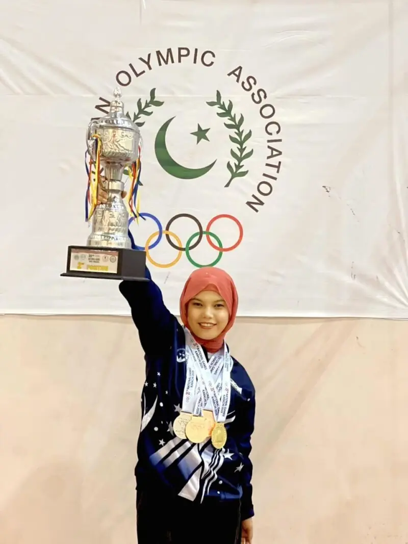  Banin poses with her medals and the team trophy at the 35th National Games. &mdash; Phoot via athlete  