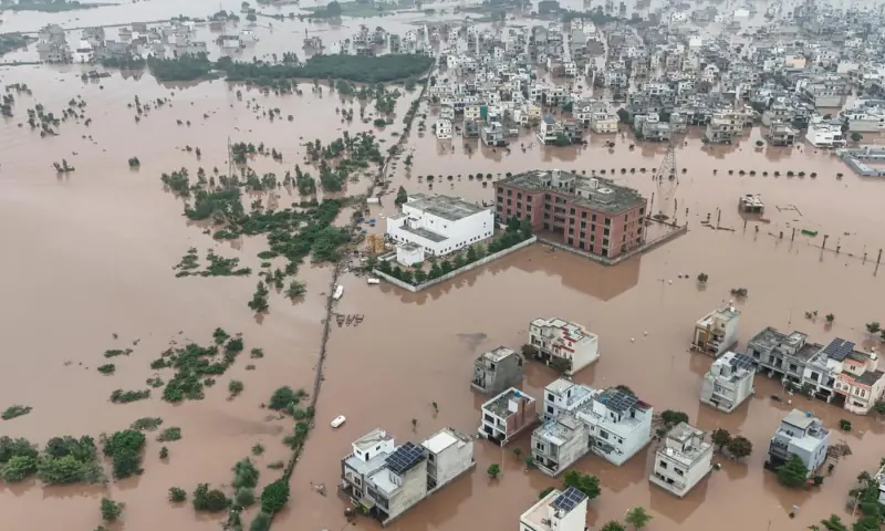 This aerial view shows partially submerged residential buildings following the overflowing of the Ravi River in Lahore on August 30, 2025. — AFP