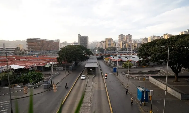 People stand in an empty street in Caracas, Venezuela, January 3, 2026. —Reuters