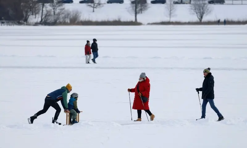 People are seen on the frozen lake “Klostersee” close to Seeon Abbey in Seeon, southern Germany, on January 6, 2026. —AFP