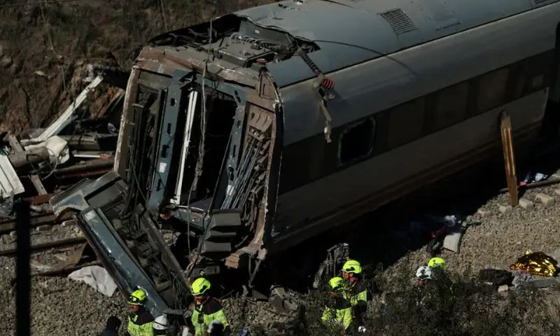   Maintenance workers from Adif near the wreckage of a train involved in the accident, at the site of a deadly derailment of two high-speed trains near Adamuz, in Cordoba, Spain on January 20. &mdash; Reuters  