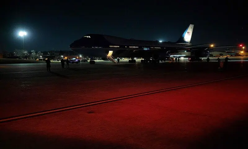 People gather outside Air Force One on the tarmac after returning to Joint Base Andrews on January 20, 2026. — AFP