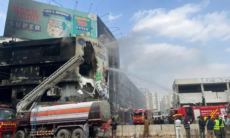  Fire trucks spray water on the Gul Plaza building. 