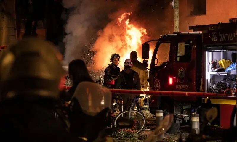  Firefighters are seen stand before a blaze at the site of an Iranian missile strike in Tel Aviv on February 28, 2026. &mdash; AFP 