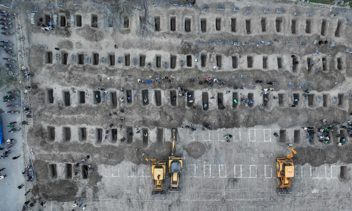 In this aerial handout picture released by the Iranian Press Centre, mourners dig graves during the funeral for children killed in a strike on a primary school in Iran&rsquo;s Hormozgan province in Minab on March 3, 2026. &mdash; AFP