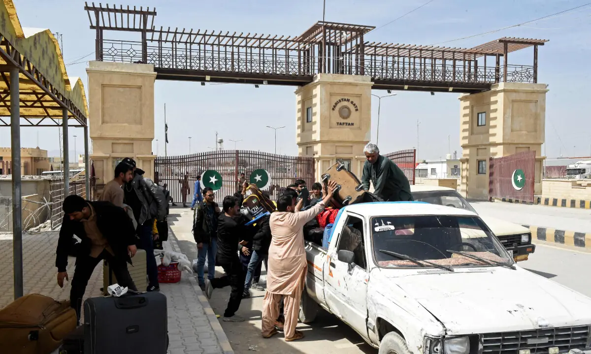 Pakistani nationals load their belongings onto a vehicle at the Pakistan-Iran border in Taftan, Balochistan province on March 5, 2026 upon their arrival from Iran amid the Middle East war. &mdash; AFP