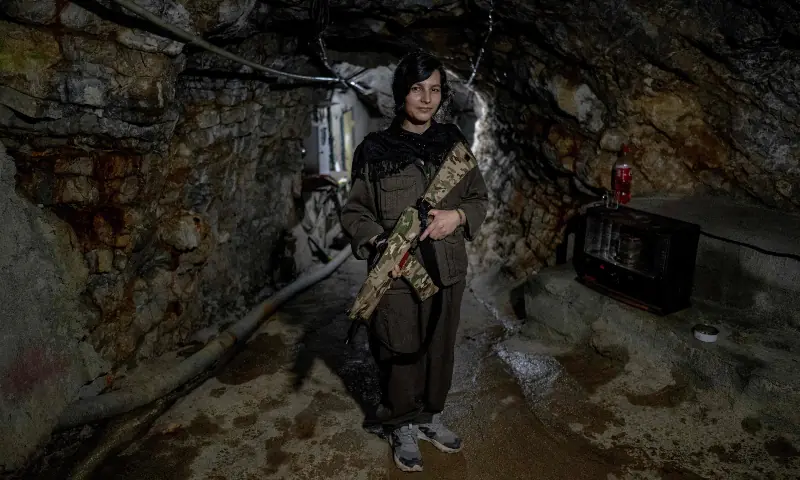 Avi, 28, a female Kurdish fighter from the Iranian Kurdish armed faction Kurdistan Free Life Party (PJAK), poses with her rifle inside a tunnel at a site near the Iraqi border with Iran in Iraq&rsquo;s autonomous Kurdistan region, on March 8, 2026. &mdash; AFP