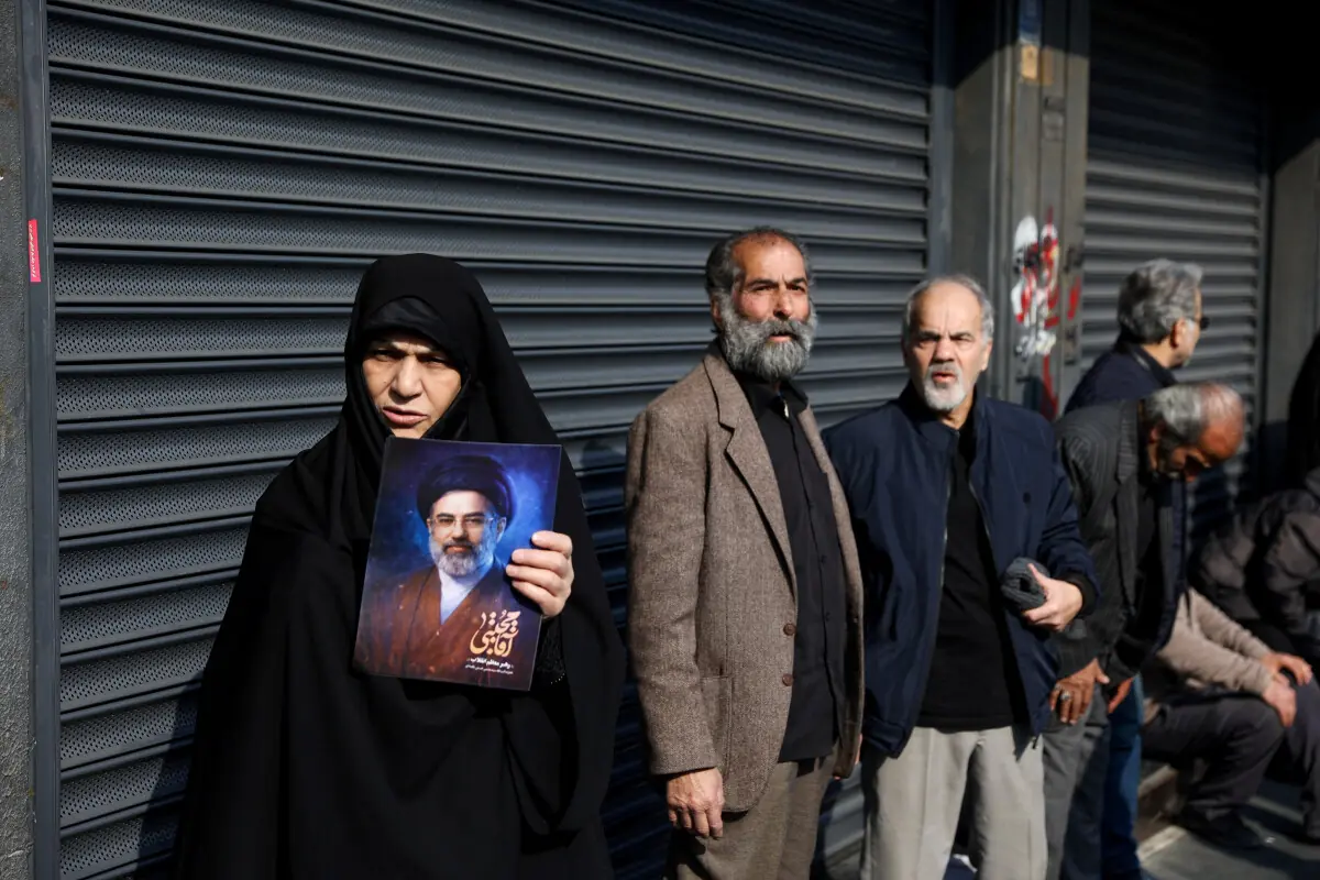 A woman holds a portrait of Iran’s new Supreme Leader Ayatollah Mojtaba Khamenei in Tehran, Iran, March 9. — AFP