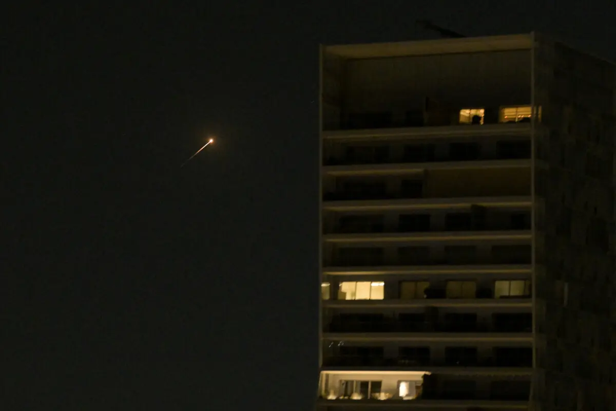 A streak of light illuminates the sky during an interception attempt made by Israel as missiles are launched from Iran amid the US-Israeli conflict with Iran, as seen from Tel Aviv, Israel, March 11, 2026. &mdash; Reuters