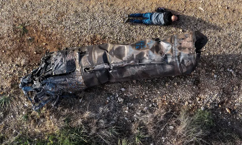 A drone view shows a drone operator taking a picture of the remains of a missile, launched by Iran into Israel, amid the U.S.-Israel conflict with Iran, in central Israel on March 11, 2026. &mdash; Reuters
