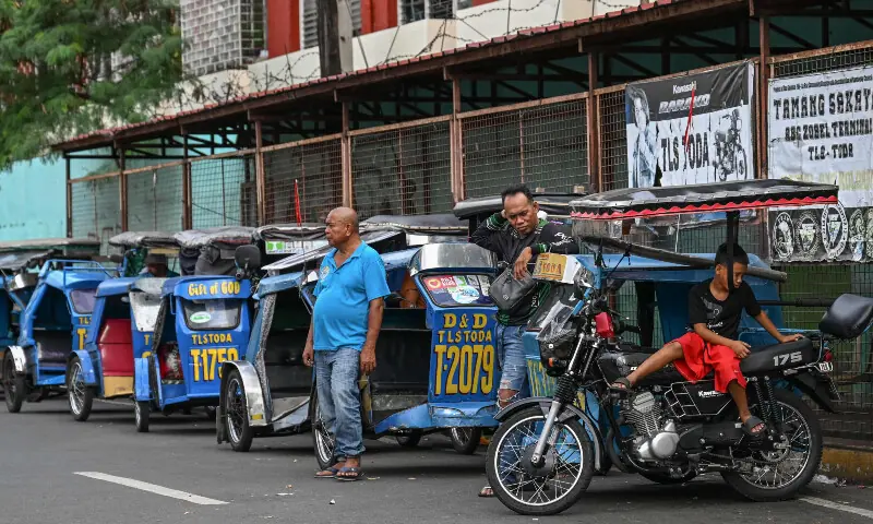 Tricycle drivers wait for passengers in Makati, Metro Manila on March 11, 2026. &mdash; AFP