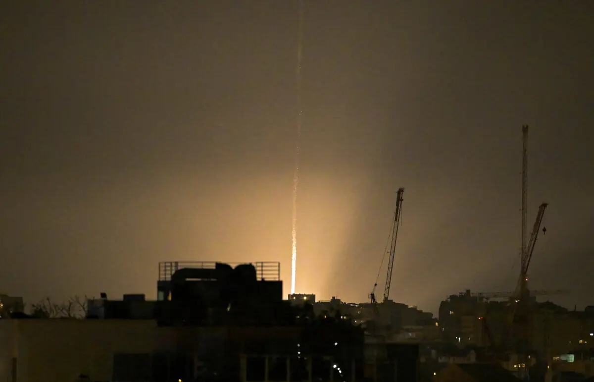 The sky is illuminated as an Iranian missile lands in Israel, amid the U.S.-Israeli conflict with Iran, as seen from Tel Aviv, Israel, March 12. &mdash; Reuters