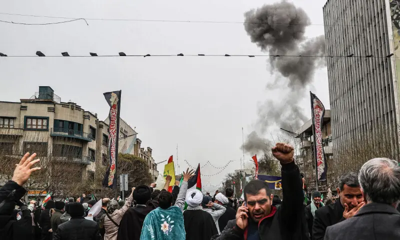 Black smoke rises following an airstrike, as Iranians take part in the Al-Quds Day rally, a commemoration in support of the Palestinian people on the last Friday of the Islamic holy month of Ramadan, in Tehran on March 13, 2026. &mdash; AFP