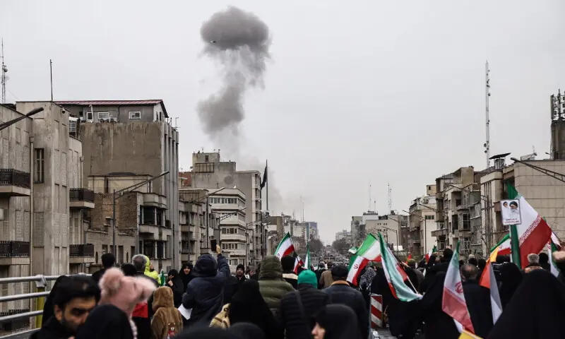 Black smoke rises following an airstrike, as Iranians take part in the Al-Quds Day rally, a commemoration in support of the Palestinian people on the last Friday of the Islamic holy month of Ramadan, in Tehran on March 13, 2026. &mdash; AFP
