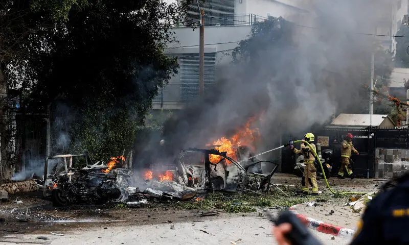 A firefighter works to put out a fire at an impact site, following missile barrages launched at Israel from Iran, in central Israel on March 15, 2026. — Reuters