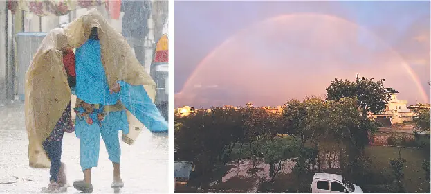  A woman and a child shield themselves from the rain in G-7 sector while a rainbow appears on the sky in Islamabad on Sunday. &mdash; Photos by Mohammad Asim &amp; Tanveer Shahzad 