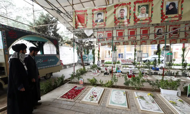 Clerics inspect the graves of those killed during strikes, at the Behesht-e Zahra cemetery, amid the US-Israeli conflict with Iran, in Tehran, Iran, March 16, 2026. — Reuters