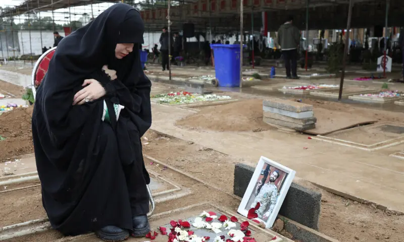 A woman reacts as she sits beside her husband’s grave at Behesht-e Zahra cemetery, amid the U.S.-Israeli conflict with Iran, in Tehran, Iran, March 16, 2026. — Reuters