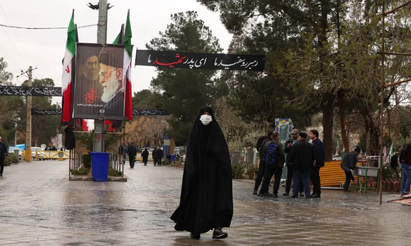 A woman enters the Behesht-e Zahra cemetery, amid the U.S.-Israeli conflict with Iran, in Tehran, Iran, March 16, 2026. — Reuters