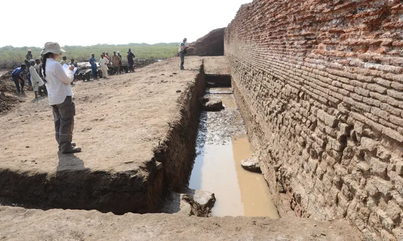 An archaeologist takes notes at the dig site.&mdash;Dawn